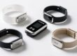 Comparison of Tyvek, silicone, vinyl and fabric RFID wristbands on clean white surface with RFID reader background