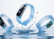 Waterproof RFID silicone wristbands submerged in water with splashes, corporate tech comparison image