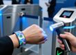 RFID wristband with holographic overlay, UV light revealing hidden security print, tamper-evident snap closure, and encrypted chip for event fraud prevention.