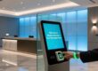 RFID wristband scanning at hotel lobby kiosk during contactless check-in process