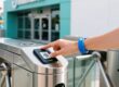 RFID wristbands for theme parks, guest tapping waterproof silicone band at entry turnstile