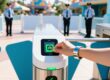Theme park entrance gate with guest scanning RFID wristband on modern turnstile reader, security team in background