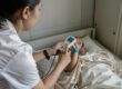 Nurse scanning RFID patient wristband in modern US hospital for medication safety