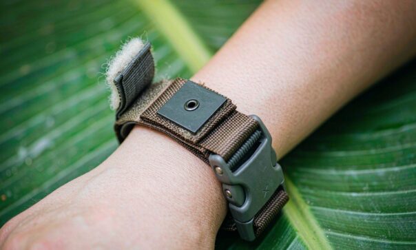 blog-cover-1791942153727 Eco-friendly reusable RFID silicone wristbands on wooden table with green leaves, sustainability concept