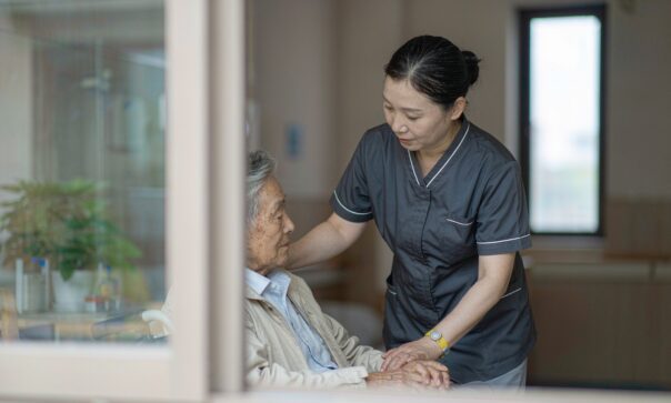 blog-cover-1791942682174 Elderly Japanese patient wearing RFID wristband while nurse scans with handheld reader in modern care facility